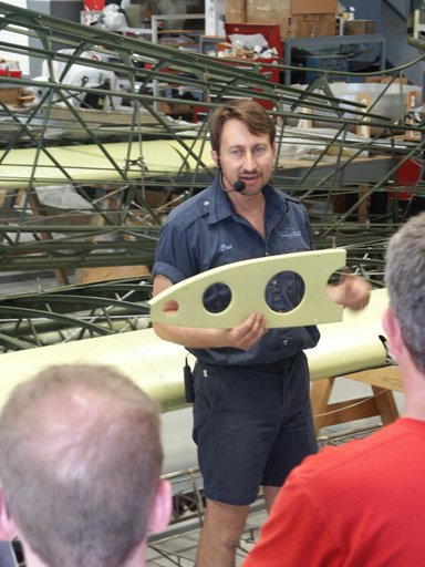 Aircraft Restoration Specialist Paul Stecewycz speaks with guests during a  tour.